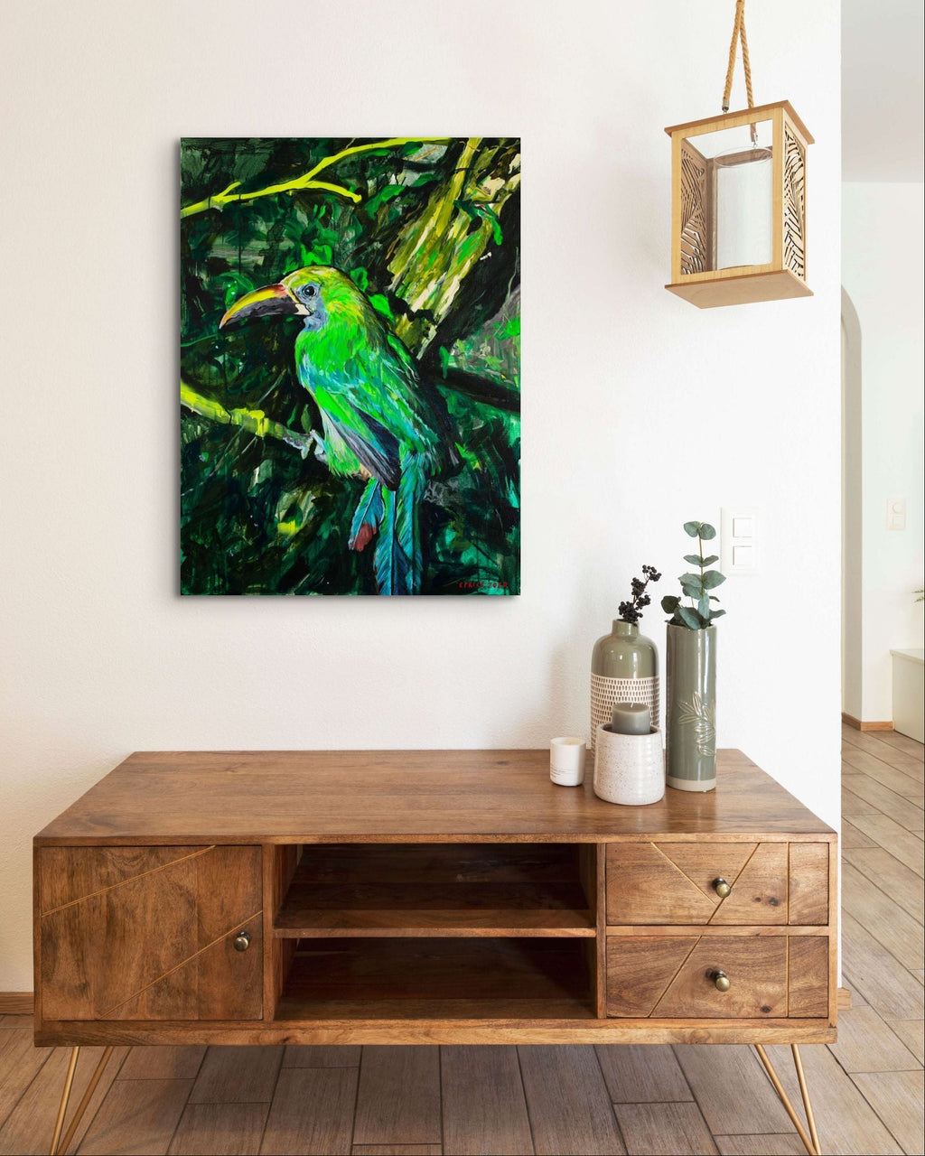 Wooden TV stand with a colorful bird painting on the wall in a modern living room.