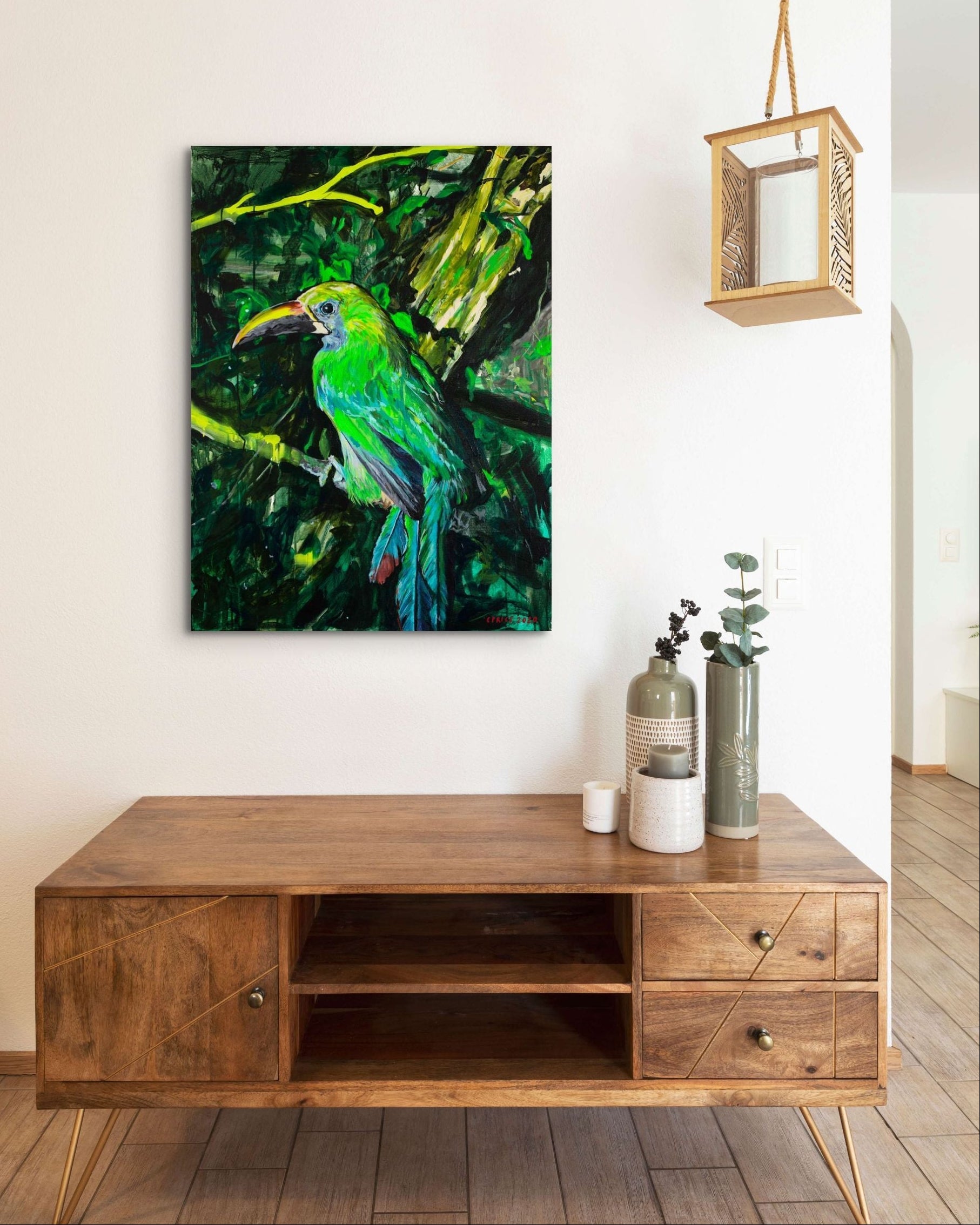 Wooden TV stand with a colorful bird painting on the wall in a modern living room.